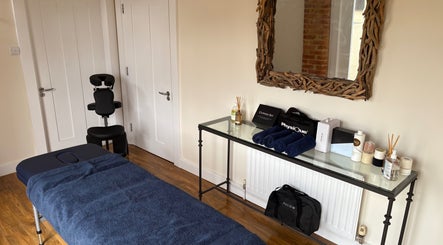 Treatment room at SRSportsRehab in Silverstone, England, GB with massage table and wellness products.