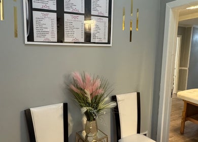 Seating area with elegant decor and service list at The Glow Factory, Columbia, South Carolina, US.