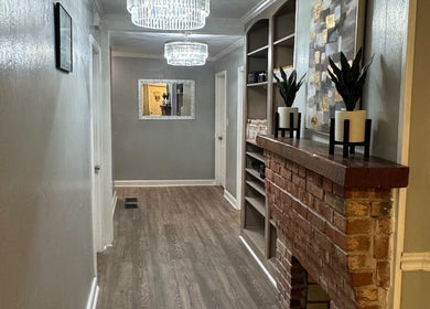 Stylish hallway at The Glow Factory, Columbia, South Carolina, US with brick feature and chic lighting.