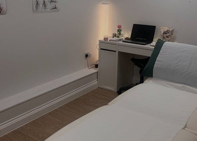 Comfortable treatment room at Lindsey Graham Physio, Chester-le-Street, England, featuring a therapy bed and desk.