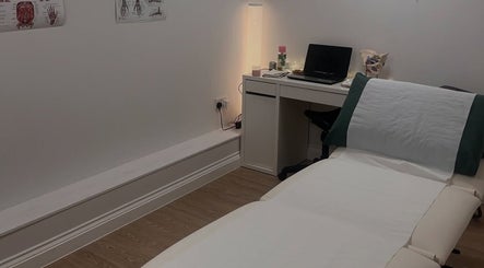 Comfortable treatment room at Lindsey Graham Physio, Chester-le-Street, England, featuring a therapy bed and desk.