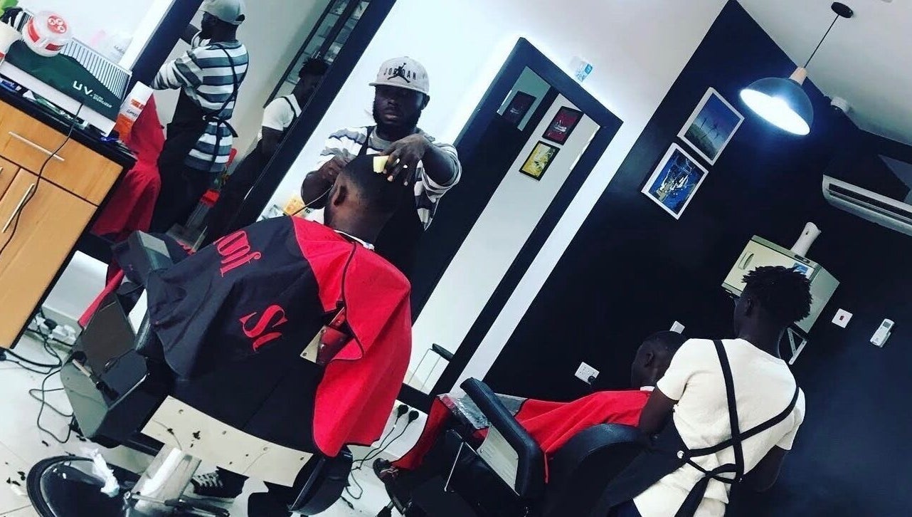 Barbers at work in Xtreme Group salon, Accra, Greater Accra Region, GH. Modern and stylish interior.