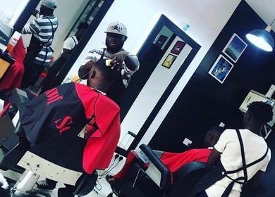 Barbers at work in Xtreme Group salon, Accra, Greater Accra Region, GH. Modern and stylish interior.