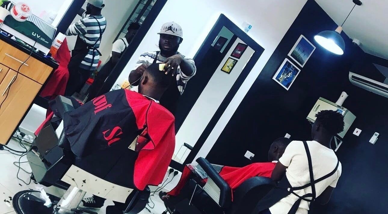 Barbers at work in Xtreme Group salon, Accra, Greater Accra Region, GH. Modern and stylish interior.