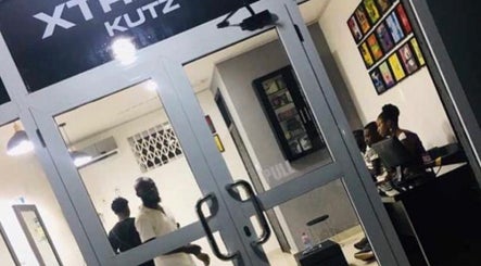 Front view of Xtreme Group salon in Accra, Greater Accra Region, GH, with people inside.