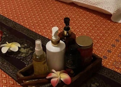 Relaxing spa oils and flowers at Wilai Thai Massage Olio, Tortona, Piemonte, IT enhance tranquility.