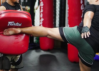 Trainer demonstrating kick technique at The Lab Boxing & Muay Thai gym - Bonifacio High Street, Metro Manila, PH.