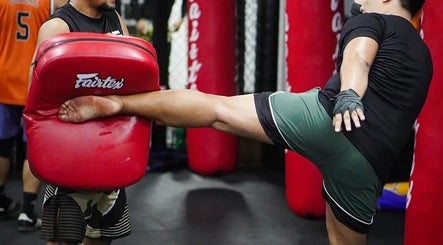 Trainer demonstrating kick technique at The Lab Boxing & Muay Thai gym - Bonifacio High Street, Metro Manila, PH.