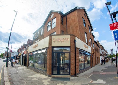 Endless Massage Therapy on a vibrant street corner in London, England, GB with elegant brick facade.