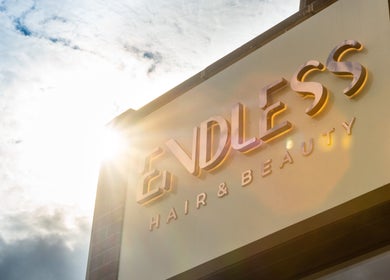 Sunlit signage of Endless Massage Therapy in London, England, GB, showcasing beauty service excellence.