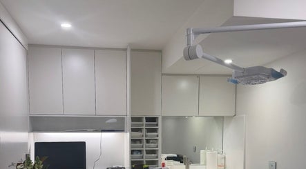 Modern treatment room at Beautified by Mads, Neutral Bay, New South Wales, AU with sleek cabinets and lighting.