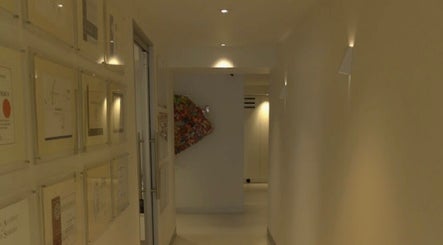 Elegant hallway at Beautified by Mads, Neutral Bay, New South Wales, AU, featuring art and certifications.