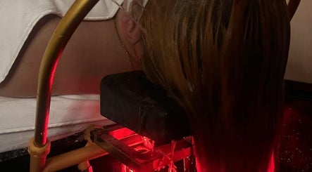 Revitalizing hair treatment at ELEGANT HEAD SPA, South Pasadena, California, US with glowing red ambiance.