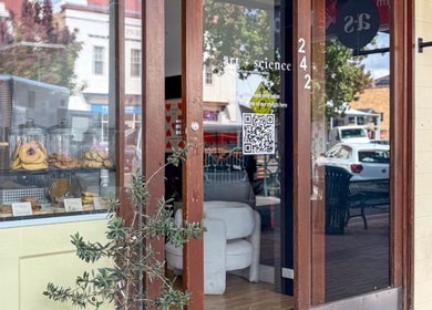 Entrance of Nails.HolliKate salon in Gunnedah, New South Wales, AU with glass doors and cozy interior.