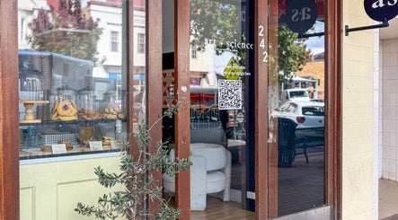 Entrance of Nails.HolliKate salon in Gunnedah, New South Wales, AU with glass doors and cozy interior.