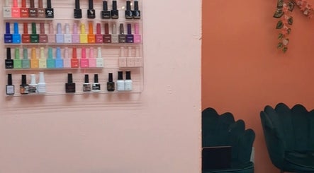 Nail polish display and seating at Zach Hair, Arima, Arima Borough Corporation, TT. Vibrant salon atmosphere.
