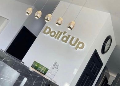 Sophisticated interior of Pmu lounge in Failsworth, England, GB with stylish decor and Doll'd Up sign.