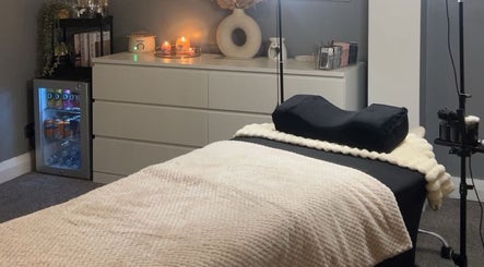 Inviting treatment room at Elegant Beauty By Lucy in Ashby-de-la-zouch, England, GB with bed and warm decor.