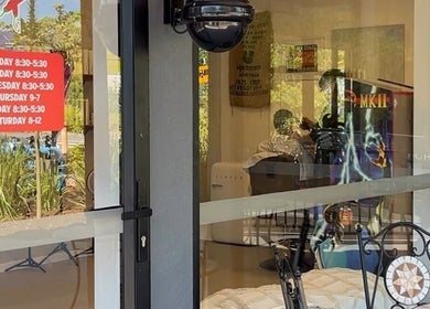 View of Piccante Barbers shopfront in Peregian Springs, Queensland, AU, showcasing vibrant interior through glass.
