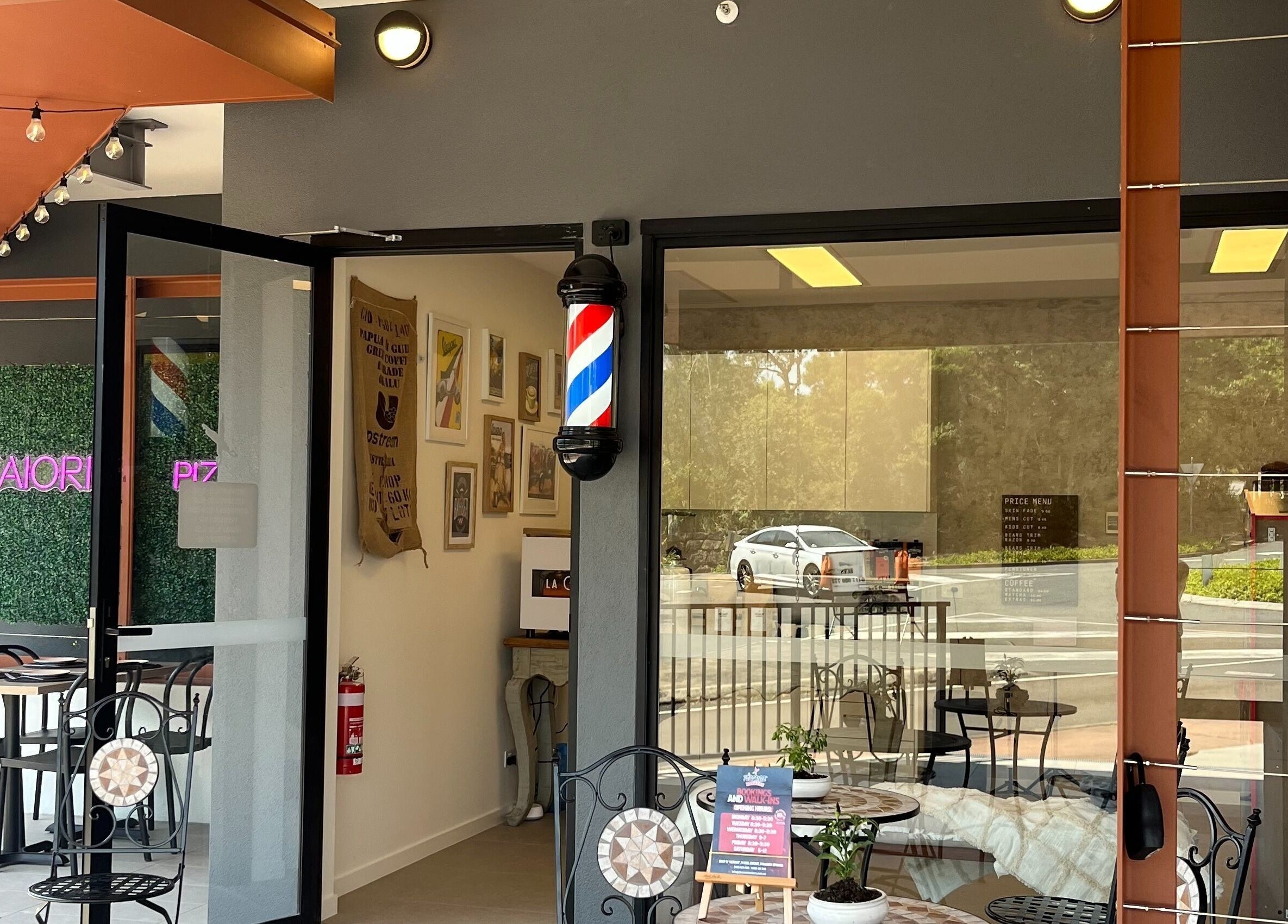 Entrance of Piccante Barbers in Peregian Springs, Queensland, AU with vintage decor and seating.
