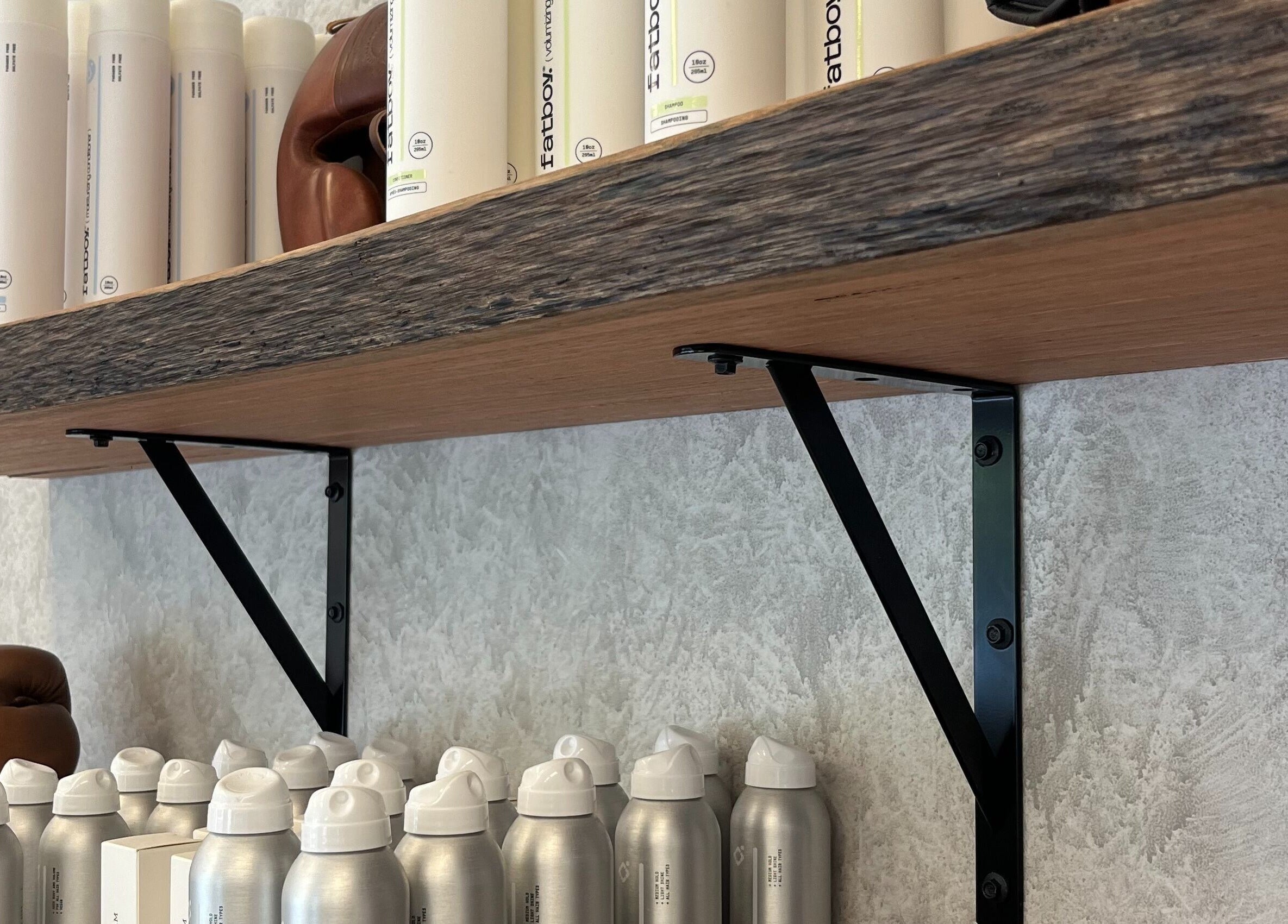 Product display on wooden shelf at Piccante Barbers, Peregian Springs, Queensland, AU, showcasing grooming items.