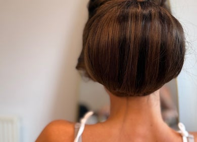 Chic updo hairstyle at The Dolls Lounge in Leeds, England, GB. Perfect for special occasions.