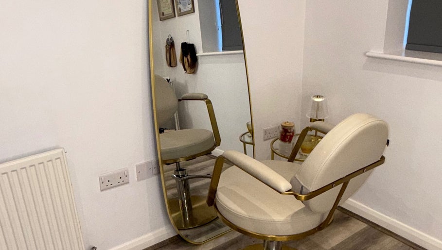 Elegant salon chair and mirror at The Dolls Lounge, Leeds, England, GB, showcasing luxury decor.