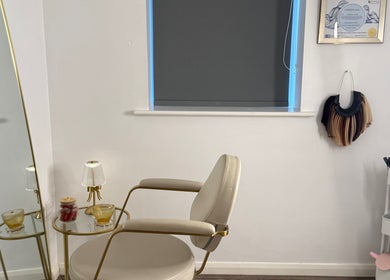 Chic beauty corner at The Dolls Lounge, Leeds, England, GB with a stylish chair and golden mirror.