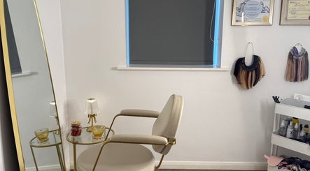 Chic beauty corner at The Dolls Lounge, Leeds, England, GB with a stylish chair and golden mirror.