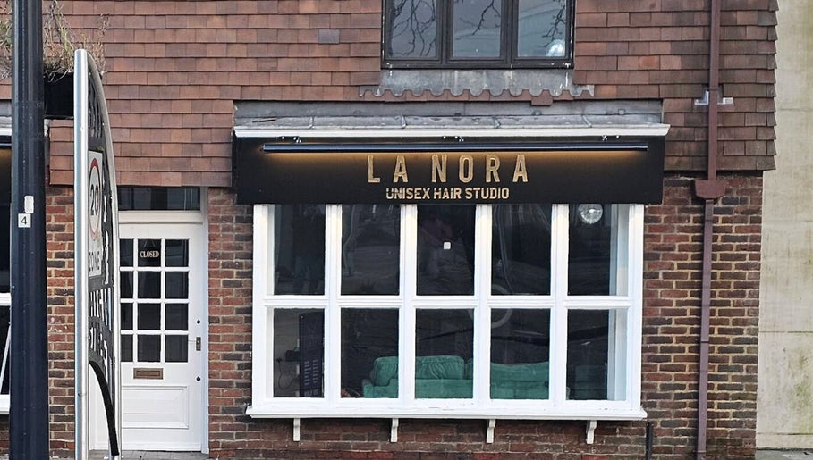 Front view of LaNora Hair Studio in Crawley, England, GB showcasing its inviting brick exterior.