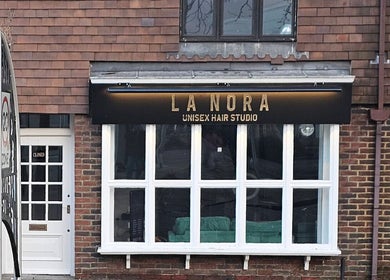 Front view of LaNora Hair Studio in Crawley, England, GB showcasing its inviting brick exterior.