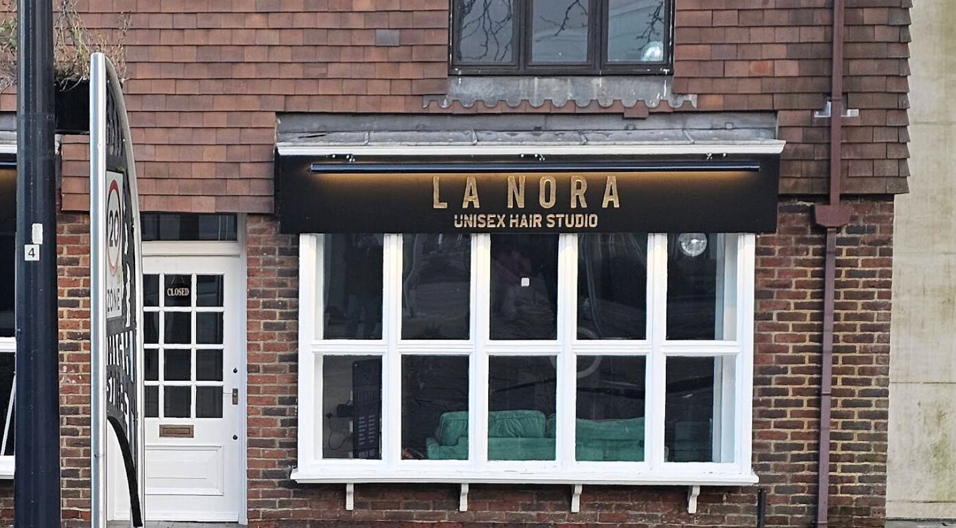 Front view of LaNora Hair Studio in Crawley, England, GB showcasing its inviting brick exterior.
