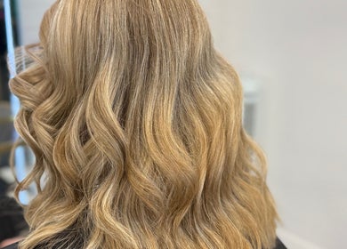 Beautiful wavy blonde hairstyle at LaNora Hair Studio, Crawley, England, GB.