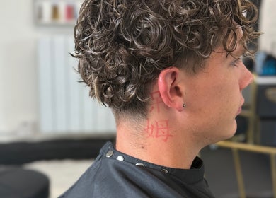 Side profile of a man with curly hair at LaNora Hair Studio, Crawley, England, GB.