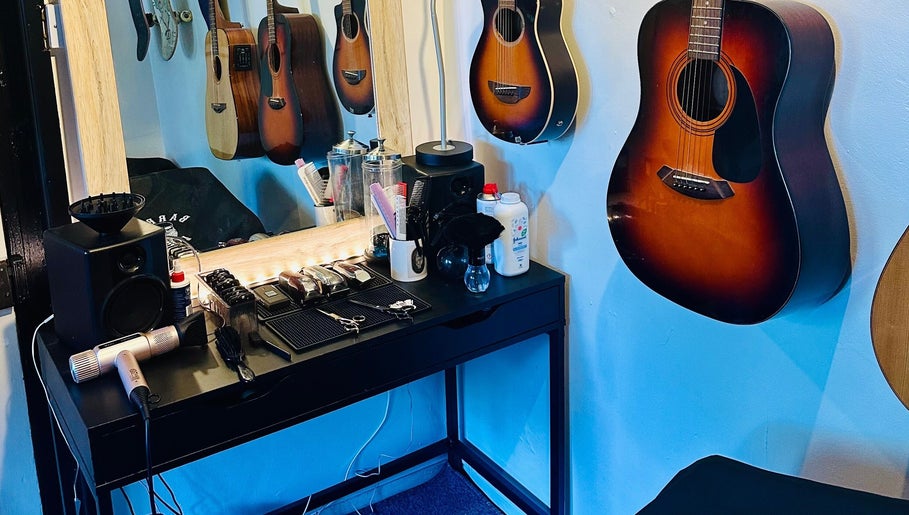 S.H.E Cuts in Nuneham Courtenay, England offers a stylish salon with guitars and hair tools for unique experiences.