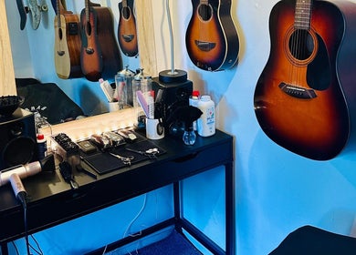 S.H.E Cuts in Nuneham Courtenay, England offers a stylish salon with guitars and hair tools for unique experiences.