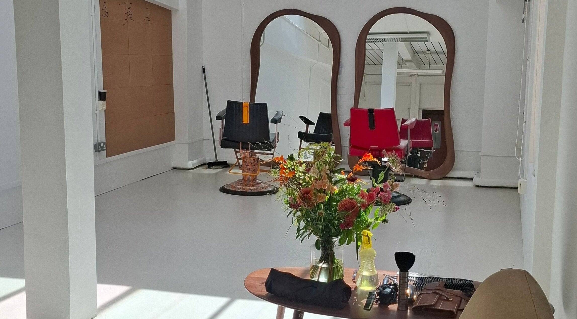 Stylish interior of Studio 117 in London, England, with modern salon chairs and mirrors.