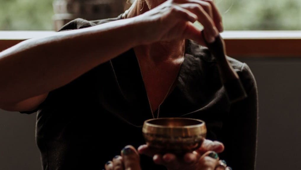 Sound therapy session at The Holistic Approach and Retreats, Ipswich, England, GB with a healing bowl.