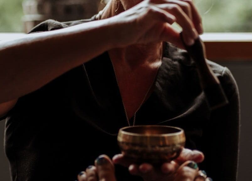 Sound therapy session at The Holistic Approach and Retreats, Ipswich, England, GB with a healing bowl.