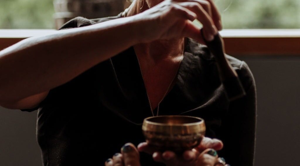 Sound therapy session at The Holistic Approach and Retreats, Ipswich, England, GB with a healing bowl.