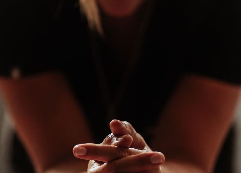 Relaxed hands on lap at The Holistic Approach and Retreats in Ipswich, England, GB, promoting tranquility.