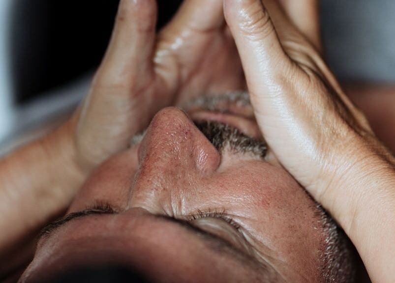 Man receiving a calming face massage at The Holistic Approach and Retreats, Ipswich, England, GB.