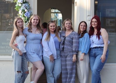 Team of women smiling outside Blow Garden in West Malling, England, GB, celebrating beauty and style.