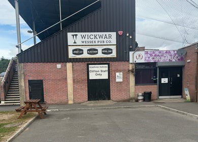 Exterior of Clifton RFC near Walk 2 Recovery Clinic, Patchway, England, GB. Brick structure with signage.