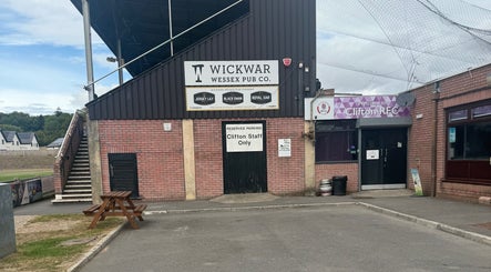 Exterior of Clifton RFC near Walk 2 Recovery Clinic, Patchway, England, GB. Brick structure with signage.