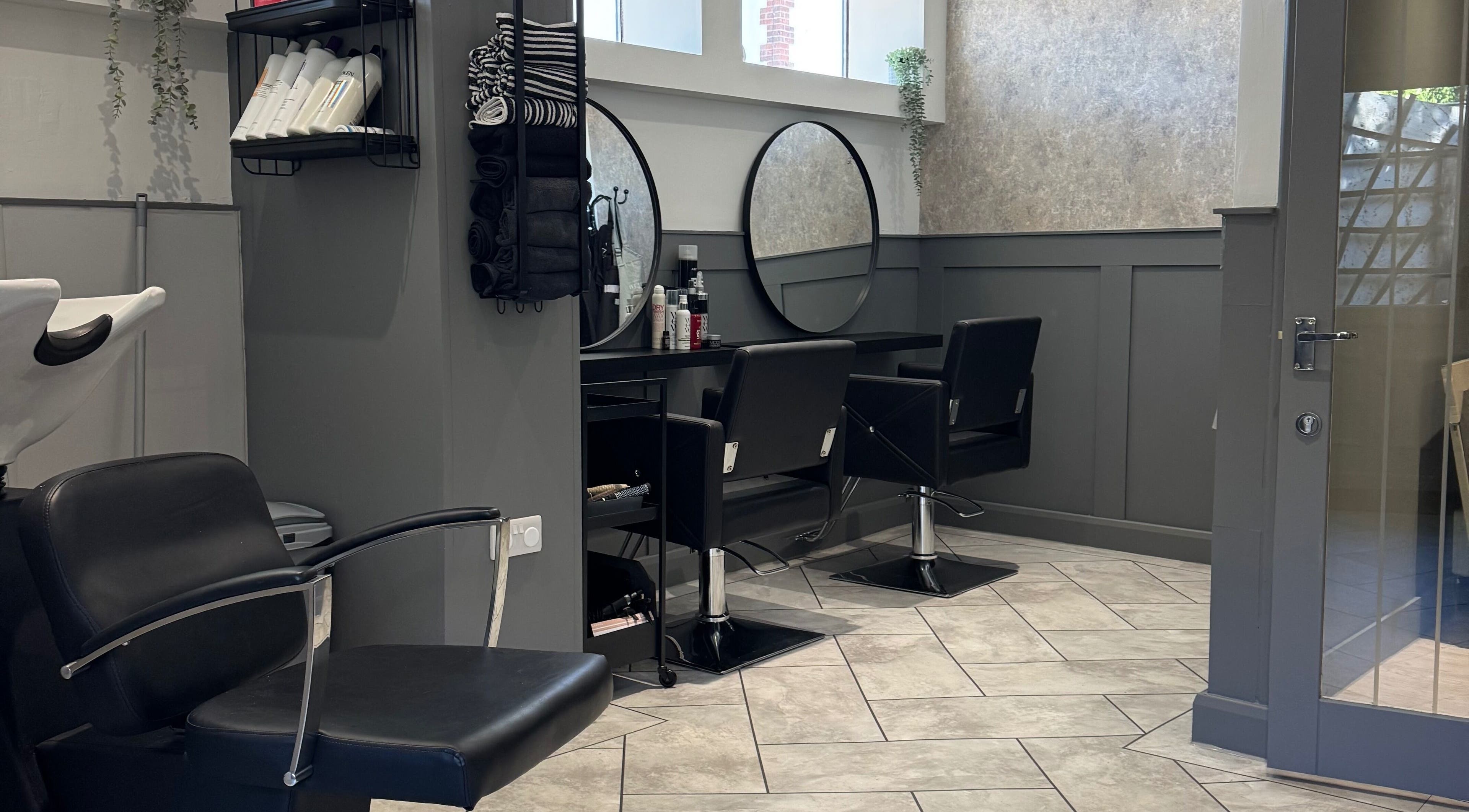 Chic hair styling area at Hair by Madison, Branston, England, GB featuring modern chairs and mirrors.