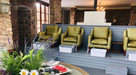 Relaxing pedicure area at Vygenhoek Spa & Farmhouse, Dullstroom, Mpumalanga, ZA with plush seating and lavender accents.