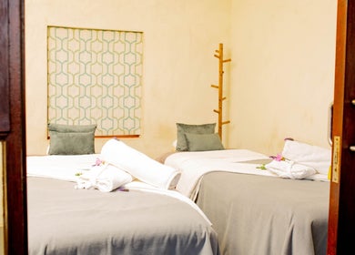 Cozy massage room at Vygenhoek Spa & Farmhouse, Dullstroom, Mpumalanga, ZA featuring twin beds and soft lighting.