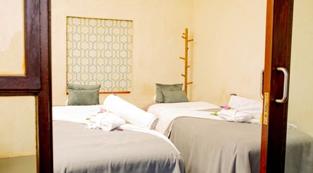Cozy massage room at Vygenhoek Spa & Farmhouse, Dullstroom, Mpumalanga, ZA featuring twin beds and soft lighting.