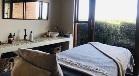 Relaxing spa room at Vygenhoek Spa & Farmhouse in Dullstroom, Mpumalanga, ZA with massage table and window view.